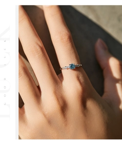 Detailed close-up of s925 silver crown ring with blue opal and square crystal stones