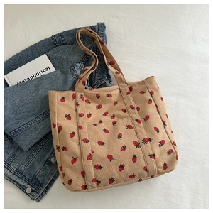 Detailweergave van corduroy shopper met aardbeienprint en een handig voorvak