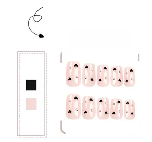 Detail of pink square press-on nails with black hearts and sparkling rhinestones