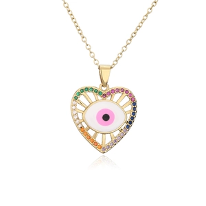 Macro shot of 18K gold heart pendant with evil eye and colorful zircon accents