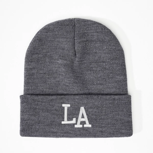 Close-up of dark grey beanie featuring 3D white LA embroidery on fine knit fabric