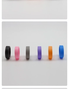 Detailed view of six colorful silicone luggage wheel covers in a minimalist row