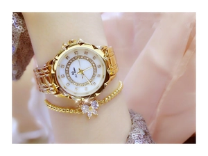 Macro shot of gold quartz watch with rhinestones and matching crystal butterfly bracelet