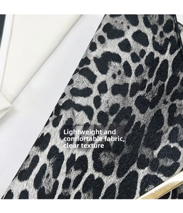 Detail of lightweight leopard print fabric texture with elegant gold metal hardware