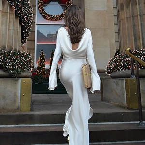 Elegant white satin backless maxi dress featuring long sleeves and high slit detail