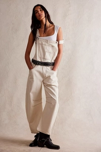 Full view of model wearing vintage washed off-white straight leg denim overalls