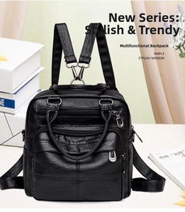 Detail of black textured faux leather backpack with multiple zipper pockets and silver buckles
