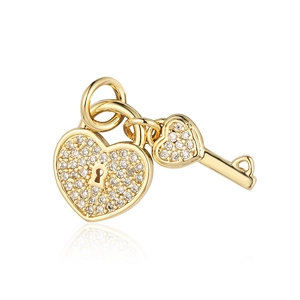 Detailed shot of a gold heart lock and key pendant with cubic zirconia stones