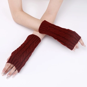 Close-up of deep red cable knit arm warmers showing detailed winter weave patterns