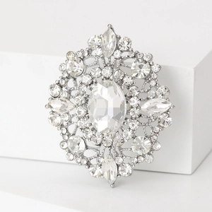 Macro shot of oval rhinestone brooch with vintage silver metal base and clear crystals