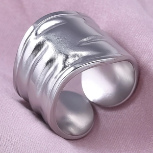 Detail view of silver 304 stainless steel wide open ring with irregular lava texture