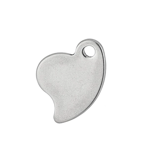 Macro view of a polished silver heart-shaped stainless steel pendant with a hanging hole