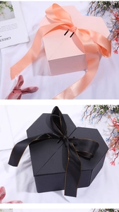 Detail of pink and black heart-shaped gift boxes with elegant ribbon bows for gifts
