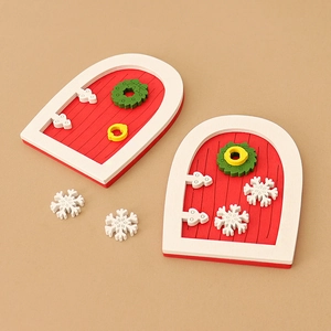 Miniature red Christmas dollhouse doors with green wreaths and white snowflake ornaments