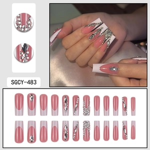 Long coffin press on nails featuring white French tips and sparkling silver rhinestones