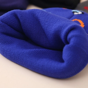 Blue knit baby beanie with orange cartoon patch for winter warmth and outdoor protection