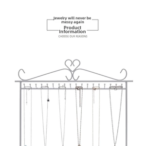White metal jewelry rack detail with heart design and ten hooks for hanging necklaces
