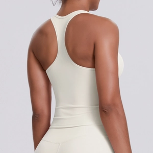 Back view of cream racerback sports bra showing ergonomic seams and matte high-stretch fabric