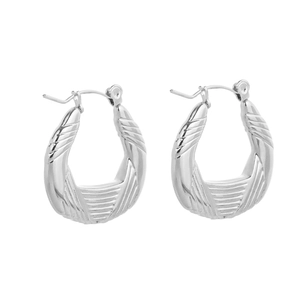 Close-up of silver tapered hoop earrings with polished diagonal engraved texture