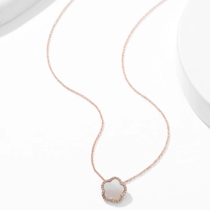Minimalist rose gold necklace featuring a zircon and mother-of-pearl flower pendant