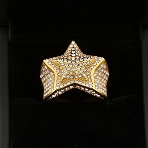 Detailed macro view of a gold-plated star ring with pavé-set cubic zirconia on black velvet