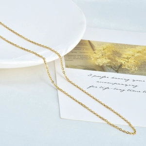 Detailed close-up of a slim 18k gold-plated stainless steel cable chain necklace