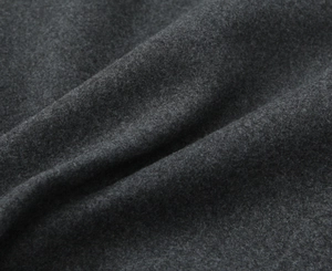 Vue macro de la texture du tissu de laine gris foncé montrant la surface en fibres douces