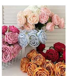Detailed view of colorful artificial rose bouquets in pink, champagne and blue tones