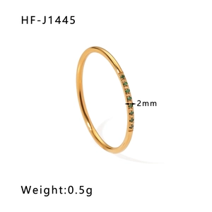 Detail shot of 2mm 18K gold plated stainless steel ring with emerald green zirconia