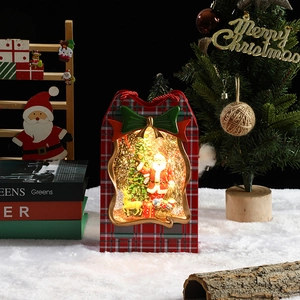 Close-up of a festive Christmas lantern music box with Santa, reindeer and warm LED lights