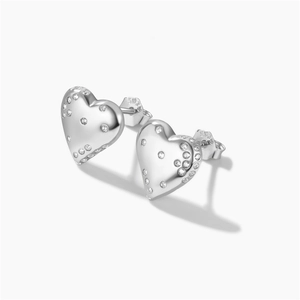 Close-up of heart-shaped 925 sterling silver stud earrings with sparkling pavé zircons