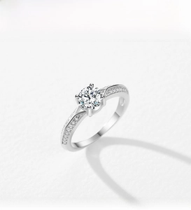 Detailed top view of S925 sterling silver ring with 4-prong set zircon and pavé accents
