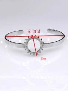 Detail showing a 6.2cm open silver cuff bracelet with a 20mm sunburst hollow design