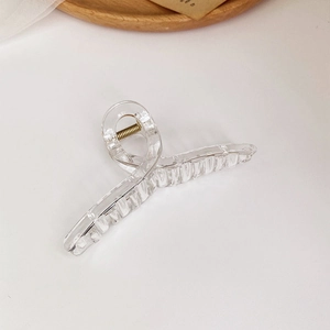 Detail of transparent square hair claw clip with metal spring on a minimal background