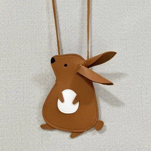 Detail of cute brown rabbit-shaped kids bag with lychee texture and fine stitching