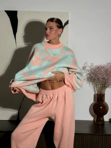 Women's knitwear set featuring flower sweater and wide-leg trousers in peach and blue