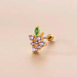 Macro detail of gold stud earring with purple zircon grapes and green zircon leaf