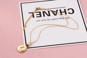 Detail view of gold-plated teardrop necklace featuring intricate zircon stone inlay