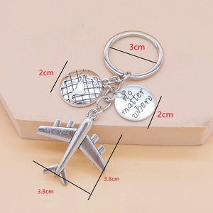 Travel keychain with mini airplane, compass map and 'no matter where' engraved tag