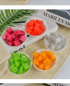 Detailed realistic artificial fruit cubes in ceramic bowls for DIY craft decoration