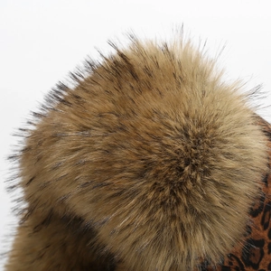 Macro shot of fluffy brown faux fur with leopard print detail on a winter earflap hat