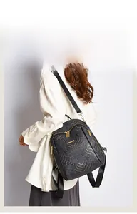 Detail of black New Chinese style backpack with golden wave pattern and metal zippers