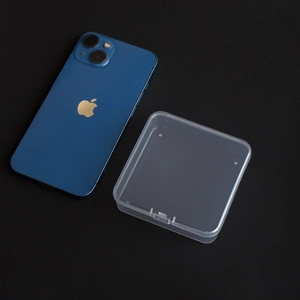 Compact square transparent PP storage box shown next to a smartphone for size scale