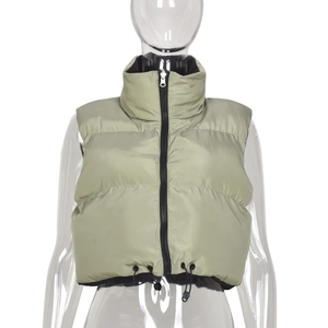 Detail of sage green quilted vest featuring a stand collar and adjustable drawstring hem
