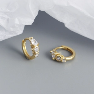 Detail of gold-plated silver hoops with cluster of teardrop and round zircon stones