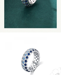 Detailed macro view of 925 silver wave ring with blue gradient pavé cubic zirconia