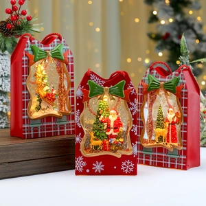 Lighted Christmas gift bag snow globe music box with Santa and reindeer scene