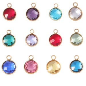 Detailed view of 12 colorful 7mm birthstone pendants with gold faceted metal frames