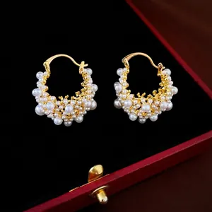 Orecchini di perle placcati in oro con design geometrico in una scatola rossa
