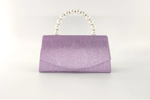 Detail of the glittering purple evening bag with a luxury pearl top handle and sequins